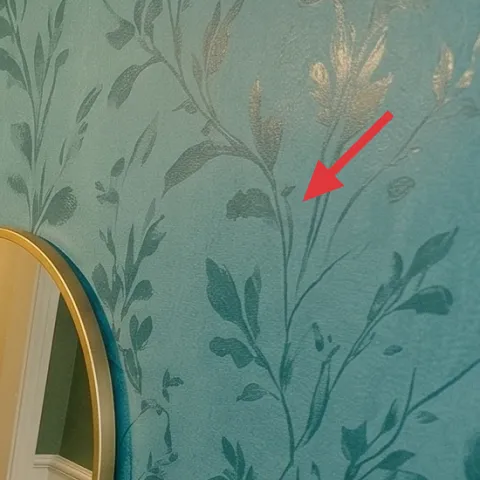 Green botanical wallpaper on right wall