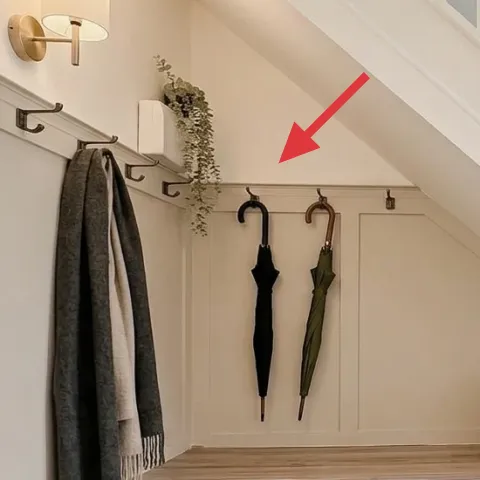 hanging greenery garland near wall hooks