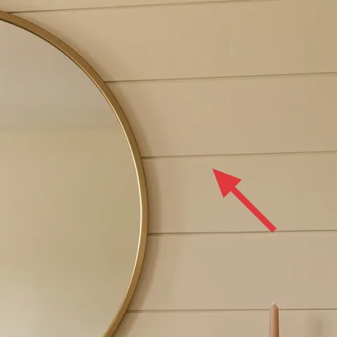 Gold-framed round mirror