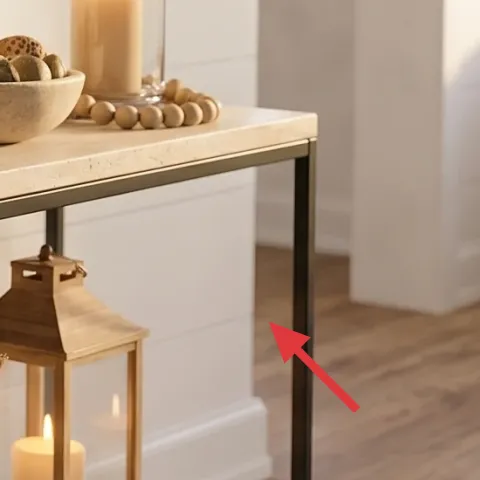 two pillar candles in a wooden lantern