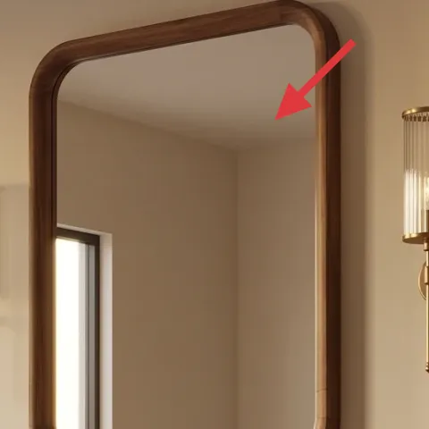 Leaning arched wood-framed mirror
