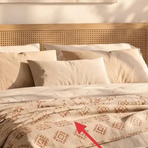 patterned throw blanket on bed