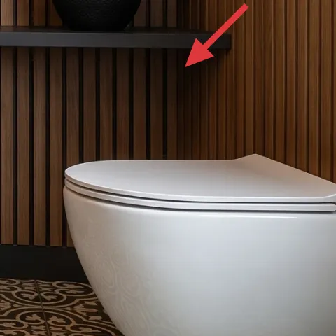 Black vase on the lower shelf