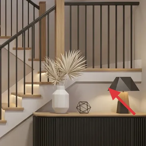 Table lamp on console cabinet
